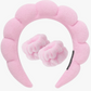 Pink plush headband with bow on a white background